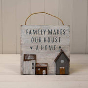 White Wooden Home Sign 'Family Makes Our House A Home' With Grey, White and Brown Stand Out Houses